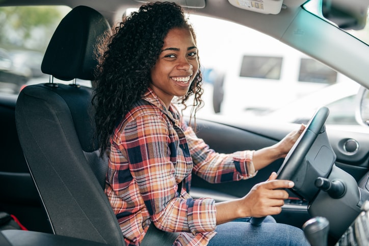 young smiling driver in car