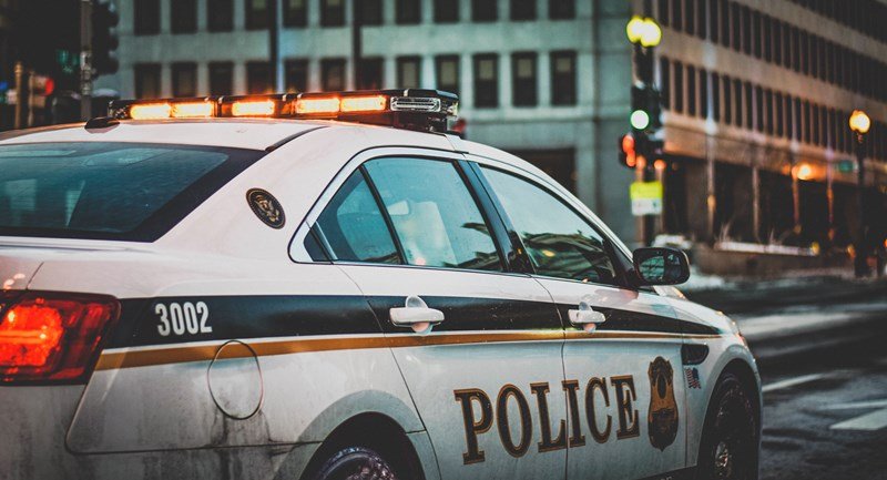 police car with flashing lights in downtown chicago