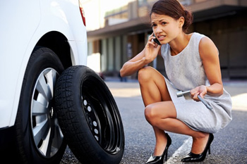 woman needs assistance with tire