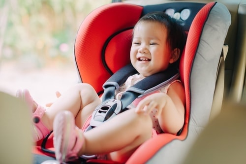young toddler in car seat